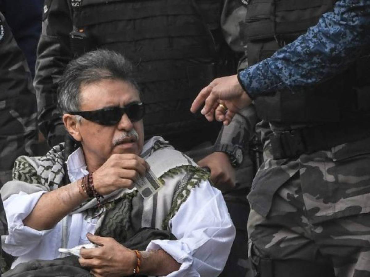 Colombian FARC political party member Jesus Santrich is escorted before being released from Colombian prison 'La Picota', in Bogota, on May 17, 2019. - Santrich -wanted by the United States for drug trafficking- was inmediately recaptured while being freed, even though a special peace court in Colombia had ordered on May 15 his 'immediate release'. (Photo by Juan BARRETO / AFP)