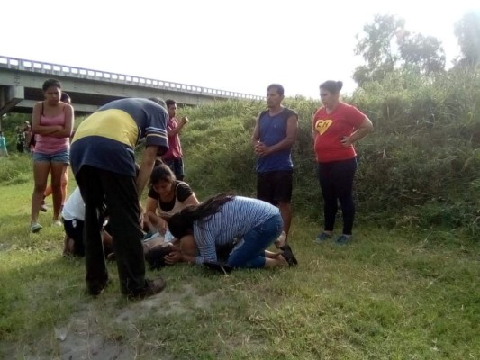 Familiares de las pequeñas lloran sobre sus cadáveres en la orilla del río Humuya.