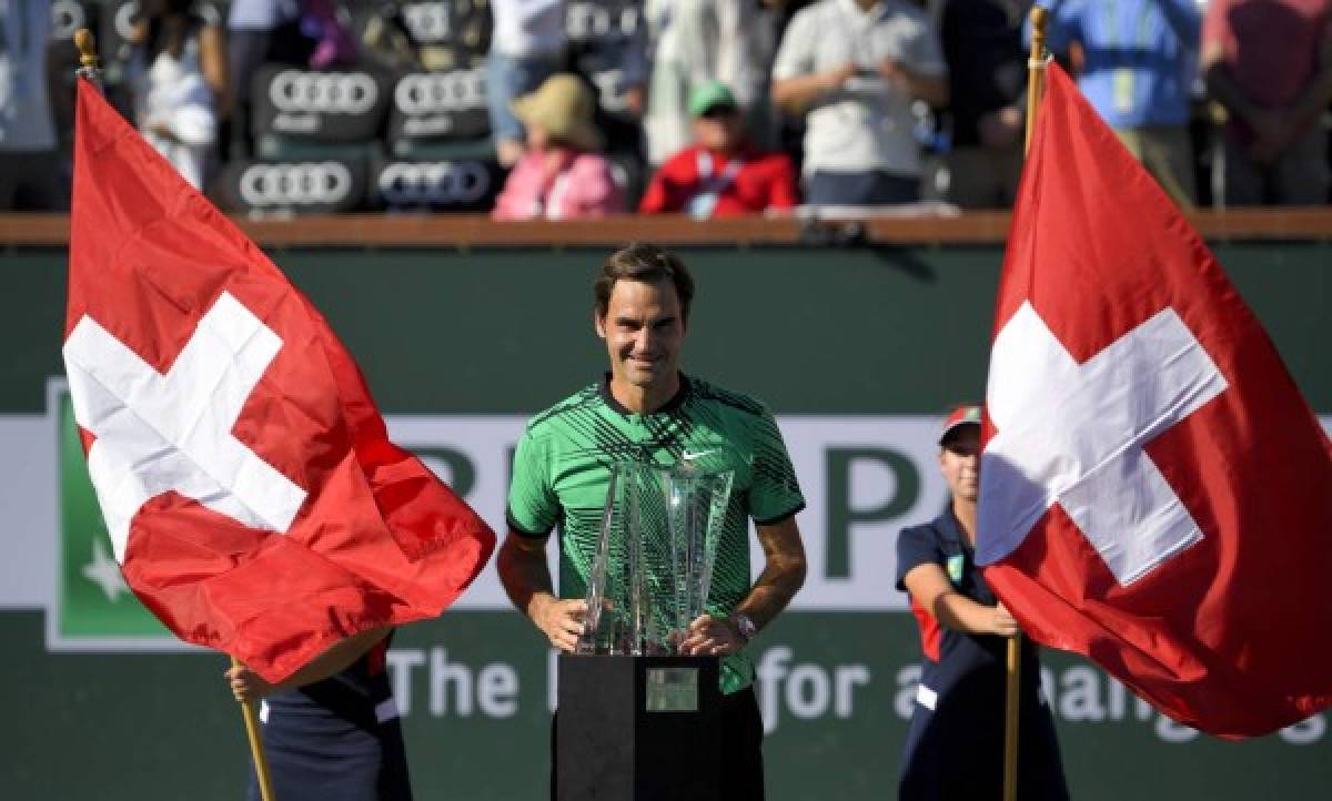 Roger Federer, of Switzerland, poses with the trophy after his win against Stanislas Wawrinka, of Switzerland, in the finals of the BNP Paribas Open tennis tournament, Sunday, March 19, 2017, in Indian Wells, Calif. (AP Photo/Mark J. Terrill)