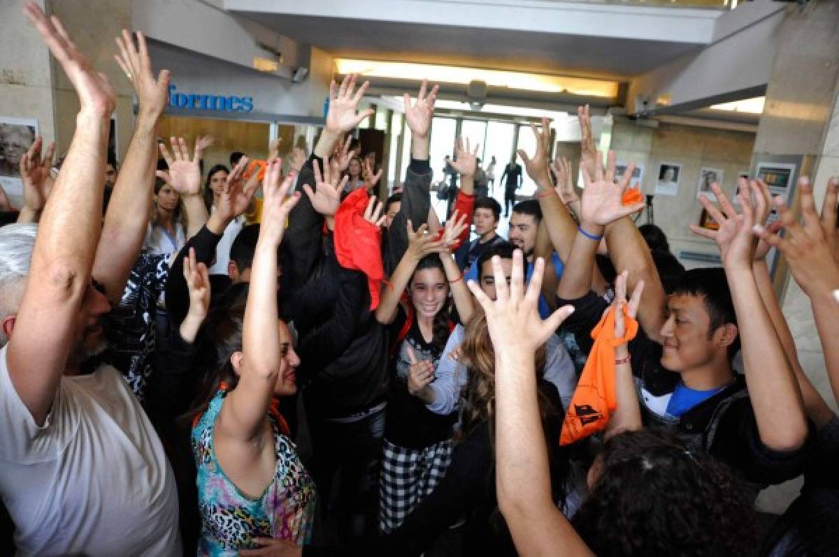 Victims of sexual abuse and relatives celebrate after learning the veredict in a case of sexual abuse at the Provolo Institute in Mendoza, at the courthouse in Mendoza, Argentina, on November 25, 2019. - Italian priest Nicola Corradi was sentenced to 42 years in prison, Argentine priest Horacio Corbacho to 45 years and former gardener Armando Gomez to 18 year for sexual abuse, corruption of children and mistreatment at a Catholic school for deaf children. (Photo by Andres Larrovere / AFP)