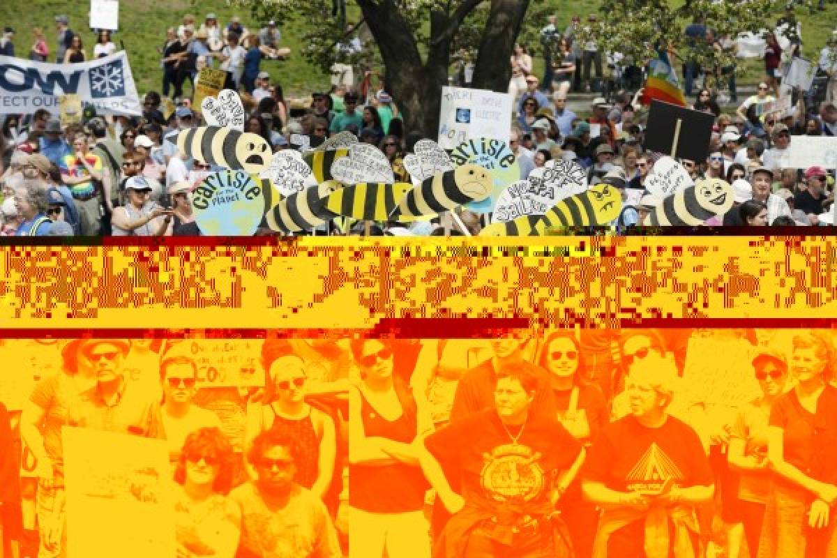 People gather for a climate rally on Boston Common in Boston, Saturday, April 29, 2017. Organizers say they’re marking President Donald Trump’s first 100 days in office by protesting his agenda so far. (AP Photo/Michael Dwyer)