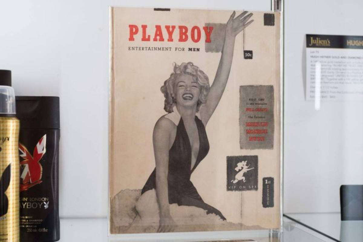 (FILES) In this file photo taken on November 26, 2018 late Playboy publisher Hugh Hefner's personal copy of the first Playboy issue featuring Marilyn Monroe is displayed as part of Julien's Auctions upcoming sale of his belongings in Beverly Hills, California. - Playboy founder Hugh Hefner embraced a hedonistic lifestyle of smoking jackets, multiple 'girlfriends' and lavish parties at his legendary mansion. Now, hundreds of fans have paid big bucks for a piece of the myth. (Photo by Robyn Beck / AFP)