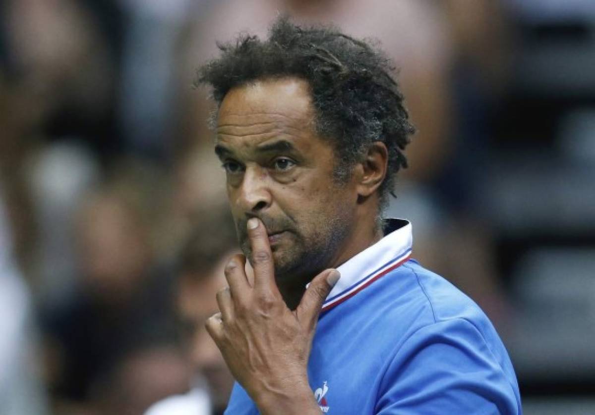 FILE - In this Sunday, Sept. 18, 2016 file photo, French team captain Yannick Noah watches the match between Croatia's Marin Cilic and France's Richard Gasquet in Zadar, Croatia. France captain Yannick Noah has warned home fans against thinking the Davis Cup quarterfinal against Britain will be easier just because Andy Murray is not playing. The top-ranked Murray was Britain’s inspirational leader when it won the trophy two years ago, but the three-time Grand Slam champion is nursing an elbow injury. (AP Photo/Darko Bandic, file)