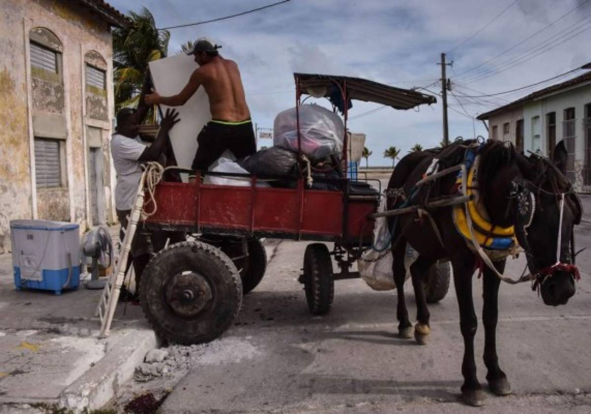 Los cubanos llevan sus pertenencias a un lugar más seguro el 8 de septiembre de 2017 antes de la llegada del huracán Irma en Caibarien. Agencia AFP.