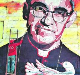 A man cleans a mural of Salvadorean Monsignor Oscar Romero (1917-1980) in Panchimalco, 20 km south of San Salvador on May 19, 2015. Monsignor Romero will be beatified next May 23. AFP PHOTO / Marvin RECINOS