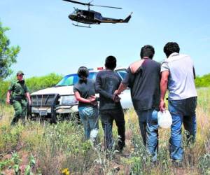 FALFURRIAS, TX - JULY 22: U.S. Customs and Border Protection agents take undocumented immigrants into custody on July 22, 2014 near Falfurrias, Texas. Thousands of immigrants, many of them minors, have crossed illegally into the United States this year, causing a humanitarian crisis on the U.S.-Mexico border. Texas Governor Rick Perry announced that he will send 1,000 National Guard troops to help stem the flow. John Moore/Getty Images/AFP