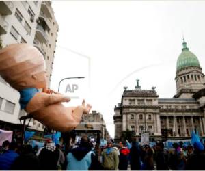 An activists against legal abortion prays during a mass prayer outside the Congress as senators debate a landmark bill on whether to legalize abortion in Buenos Aires, on December 29, 2020. - Argentina's Senate on Tuesday began debating a landmark bill on whether to legalize abortion in a country where the Catholic Church has long held sway, with the vote expected to be razor-thin. (Photo by Emiliano Lasalvia / AFP)
