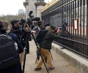 Fotografía de archivo del viernes 9 de abril de 2021, de miembros de los medios de comunicación tomando imágenes de un anuncio sobre la muerte del príncipe Felipe de Gran Bretaña, exhibido en la cerca del Palacio de Buckingham en Londres. Foto: AP