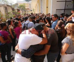 Los familiares de Génesis Colindres se fundieron en abrazos, mientras sepultaban a la joven centralista que murió asesinada por disparos que le infirieron desconocidos. Fotos Estalin Irías/ EL HERALDO