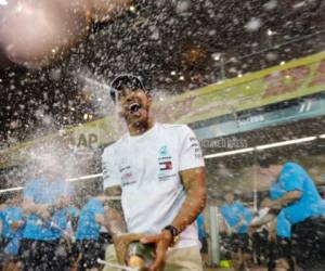 El piloto de Mercedes Lewis Hamilton rocía champaña luego de ganar el Gran Premio de Abu Dabi, en el circuito Yas Marina, el domingo 25 de noviembre de 2018.