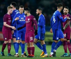 Manchester City y Cardiff City, en azul, los jugadores se dan la mano al final del partido de fútbol de la cuarta ronda inglesa FA Cup. Foto: AP