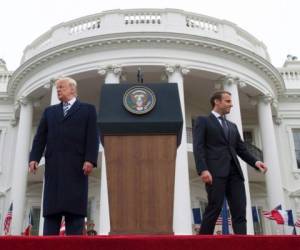 (FILES) In this file photo taken on April 24, 2018 (COMBO) This combination of pictures created on April 24, 2018 showsFrench President Emmanuel Macron and US President Donald Trump attitudes during a state visit in Washington, DC, on April 23 and 24, 2018.Firm handshakes, warm embraces, kisses, even a bit of grooming: the 'bromance' between US President Donald Trump and French leader Emmanuel Macron has provided plenty of material for America's late night TV comedians.'Trump and Macron have an interesting relationship,' comedian Jimmy Kimmel said on his talk show on ABC.'Trump very much needs a friend, because most of his old ones are going to prison,' Kimmel said, in a reference to the US president's legal woes.'And Donald Trump, really, he cannot keep his hands off this guy,' Kimmel said before showing television clips of affectionate embraces between the pair. / AFP PHOTO