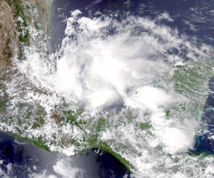 This June 19, 2013 NASA Aqua satellite image shows Tropical Strom Barry. The second tropical storm of the Atlantic hurricane season, Barry, was to make landfall June 20 in Veracruz, Mexico, bringing heavy rains and potentially life-threatening flash floods. The US National Hurricane Center in Miami said that at 1200 GMT, Barry was located about 30 miles (45 kilometers) northwest of Veracruz and moving westward at about three miles (five kilometers) per hour. The storm, packing maximum sustained winds of 45 miles (75 kilometers) per hour, was expected to cross just northwest of Veracruz before moving inland over southern Mexico during the day. AFP PHOTO / HO / NASA == RESTRICTED TO EDITORIAL USE / MANDATORY CREDIT: 'AFP PHOTO / NASA/ NO SALES / NO MARKETING / NO ADVERTISING CAMPAIGNS / DISTRIBUTED AS A SERVICE TO CLIENTS ==