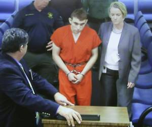 Vistiendo el uniforme anaranjado de la prisión, Nikolas Cruz, de 19 años, se sentó con la cabeza gacha durante la audiencia ante la jueza Elizabeth Scherer, en Fort Lauderdale, Florida. Foto: AFP