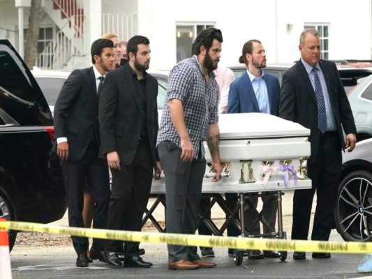 Un féretro decorado con listones color azul y blanco. y que contiene los restos de Lucia y Emma Guera, es llevado por Marcus Guara y su familia para el servicio funerario en la iglesia de St. Joseph, el martes 6 de julio de 2021, en Miami Beach, Florida. (AP Foto/Lynne Sladky).