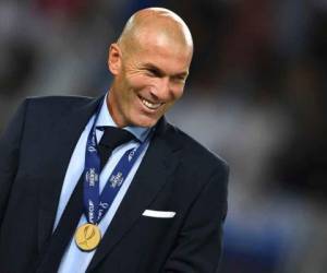 Real Madrid's French coach Zinedine Zidane smiles with his medal after winning the UEFA Super Cup football match between Real Madrid and Manchester United on August 8, 2017, at the Philip II Arena in Skopje. / AFP PHOTO / Dimitar DILKOFF