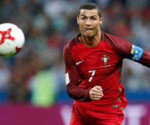 Portugal's Cristiano Ronaldo keeps his eyes on the ball during the Confederations Cup, semifinal soccer match between Portugal and Chile, at the Kazan Arena, Russia, Wednesday, June 28, 2017. (AP Photo/Pavel Golovkin)