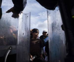 Desafiando a Trump, cientos de los miles de centroamericanos que conforman la caravana se manifestaron casi al mismo tiempo que el despliegue de las fuerzas estadounidenses, en el cercano paso de El Chaparral.(Foto: AFP)