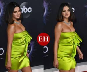 Selena Gómez optó por un vestido en tonalidad fosforescente. Para muchos lució sexy, para otros fue una elección desacertada porque resaltó su figura con sobrepreso. Fotos AFP