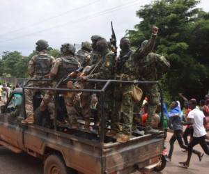 La gente celebra en las calles con miembros de las fuerzas armadas de Guinea después del arresto del presidente de Guinea, Alpha Conde, en un golpe de estado en Conakry, el 5 de septiembre de 2021. Foto: AFP