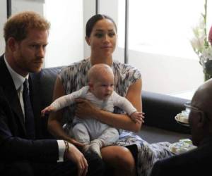 FILE - In this Wednesday, Sept. 25, 2019 file photo, Britain's Prince Harry and Meghan, Duchess of Sussex, holding their son Archie, meet with Anglican Archbishop Emeritus, Desmond Tutu, and his wife Leah in Cape Town, South Africa. The Duchess of Sussex has settled a claim against Splash News and Picture Agency, with the agency agreeing not to take any photos of her, her husband the Duke of Sussex or their son Archie, should it come out of administration, the High Court has heard. Meghan brought privacy and data protection claims against Splash in March this year over âlong lensâ photographs taken of her and her son in a Canadian park in January. (Henk Kruger/African News Agency via AP, Pool, File)