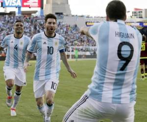 Argentina's Gabriel Mercado (4) and Lionel Messi (10) celebrate a goal by Gonzalo Higuain (9) during the first half of a Copa America Centenario quarterfinal soccer match against Venezuela on Saturday, June 18, 2016, in Foxborough, Mass. (AP Photo/Charles Krupa)