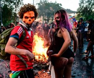 Manifestantes disfrazados participan en una protesta contra las políticas económicas del gobierno en Santiago, el 31 de octubre de 2019, durante las celebraciones de Halloween.