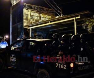A pick-up truck loaded with the bodies of dead inmates is parked in the Tela prison where at least 18 prisoners were killed during an prisonerâs riot on Friday in Tela, Honduras, Saturday, Dec. 21, 2019. The riot came several days after Honduras declared a state of emergency in its prison system. (AP Photo/Delmer Martinez)