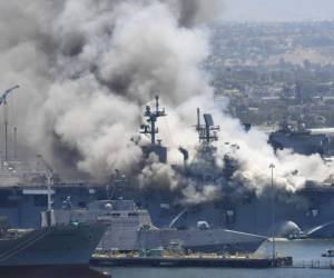 Una enorme columna de humo se eleva sobre el buque USS Bonhomme Richard en la base naval de San Diego. Foto: AP.