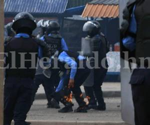 Efectivos de la Policía Nacional y miembros del Movimiento Estudiantil Universitario (MEU) protagonizaron un nuevo enfrentamiento este miércoles. En el percance cuatro efectivos resultaron con quemaduras en sus piernas. Foto Estalin Irías/EL HERALDO