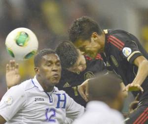 Brayan Beckeles se enfrasca en una dura pelea por el control de la pelota contra dos atacantes mexicanos.