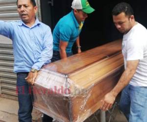 Momento en que familiares registran el cuerpo de la tercera víctima de la masacre en la colonia Betania. Foto: Estalin Irías/ EL HERALDO.