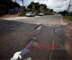 Entre la salida de la residencial Honduras y el desvío a la salida al Oriente, los baches y grietas son parte de la calle. Foto: Emilio Flores/EL HERALDO