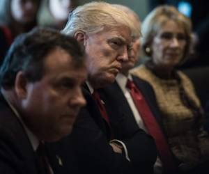 US President Donald Trump listens to a speaker during a meeting about opioid and drug abuse in the Cabinet Room at the White House in Washington, DC, on March 29, 2017. / AFP PHOTO / NICHOLAS KAMM