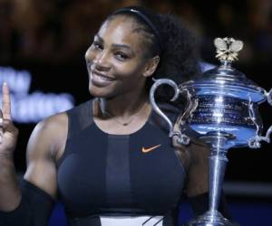 FILE - In this Jan. 28, 2017, file photo, Serena Williams holds up a finger and her trophy after defeating her sister, Venus, in the women's singles final at the Australian Open tennis championships in Melbourne, Australia. Williams posed nude for the cover of Vanity Fair in an image released by the magazine on June 27, 2017. (AP Photo/Aaron Favila, File)