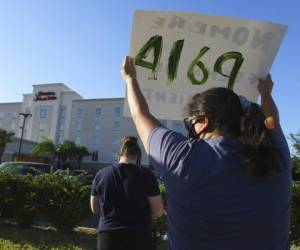 En esta fotografía de archivo del 23 de julio de 2020, manifestantes muestran pancartas frente al hotel Hampton Inn en McAllen, Texas, el cual ha sido utilizado como centro de detención de niños inmigrantes. Foto: AP