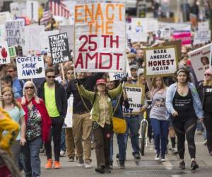 SEATTLE, WA - JUNE 3: Demonstrators march through Seattle during an anti-Trump 'March for Truth' rally on June 3, 2017 in Seattle, Washington. Rallies and marches are taking place across the country to call for urgent investigation into possible Russian interference in the U.S. election and ties to U.S. President Donald Trump and his administration. David Ryder/Getty Images/AFP== FOR NEWSPAPERS, INTERNET, TELCOS & TELEVISION USE ONLY ==