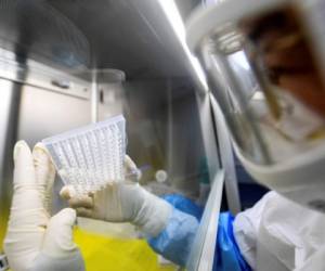 In this Thursday, Feb. 6, 2020, photo, an employee works in the pop-up Huoyan Laboratory specialized in the nucleic acid test on 2019-nCoV in Wuhan in central China's Hubei province. The coronavirus continues to spread as of Friday, Feb. 7, 2020, China reported more than 31,000 cases. (Chinatopix via AP)