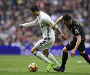 Cristiano Ronaldo mientras era marcado por el jugador del Espanyol Javi Fuego (Fotos: AFP / Deportes EL HERALDO)