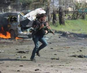 Abd Alkader Habak corre con el menor en sus brazos para evitar que sea alcanzado por el ataque. Foto: Omar Ghabra/Twitter.