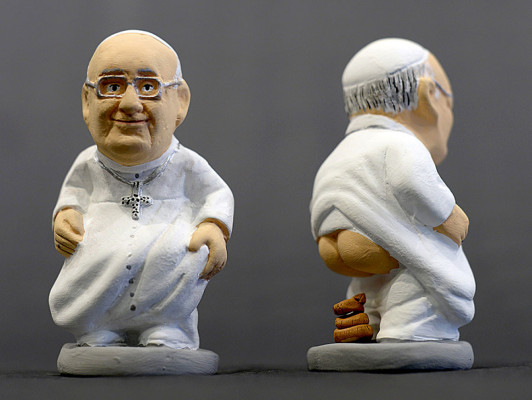 Ceramic figurines of Pope Francis called 'Caganers' are pictured during their presentation in Torroella de Montgri, near Gerona on November 15, 2013. Statuettes of well-known people defecating are a strong Christmas tradition in Catalonia, dating back to the 18th century as Catalonians hide caganers in Christmas Nativity scenes and invite friends to find them. The figures symbolize fertilization, hope and prosperity for the coming year. AFP PHOTO/ LLUIS GENE