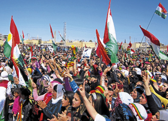 Syrian Kurds wave the Kurdish flag as they rally against the Syrian regime and to mark Noruz spring festivities in the northern city of Qamishli on March 21, 2012. Noruz marks the spring equinox of the solar year 1390. The United Nation's general assembly in 2010 recognized the International Day of Noruz, describing it as a festival of Persian origin which has been celebrated for over 3000 years. AFP PHOTO/STR