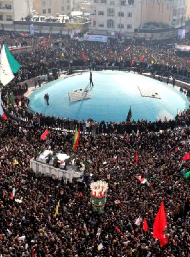 Mourners gather to pay homage to slain Iranian military commander Qasem Soleimani, Iraqi paramilitary chief Abu Mahdi al-Muhandis and other victims of a US attack, in the capital Tehran on January 6, 2020. - Mourners packed the streets of Tehran for ceremonies to pay homage to Soleimani, who spearheaded Iran's Middle East operations as commander of the Revolutionary Guards' Quds Force and was killed in a US drone strike on January 3 near Baghdad airport. (Photo by Atta KENARE / AFP)