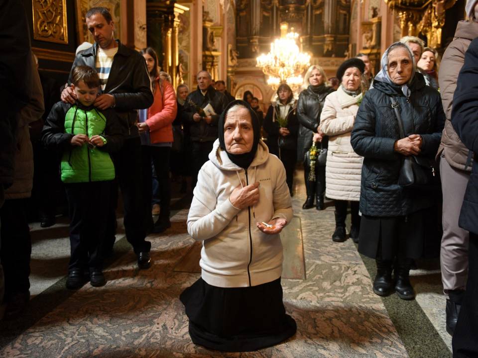 Los fieles participan en un servicio ortodoxo del Domingo de Ramos en la Iglesia de los Santos Pedro y Pablo en la ciudad ucraniana occidental de Lviv el 17 de abril de 2022, en medio de la invasión rusa de Ucrania.