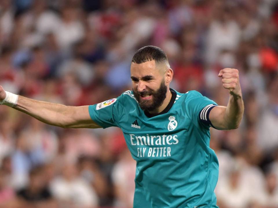 El delantero francés Karim Benzema celebra después de que el defensa Nacho Fernández marcara un gol durante el partido de fútbol de la Liga Española entre el Sevilla FC y el Real Madrid.