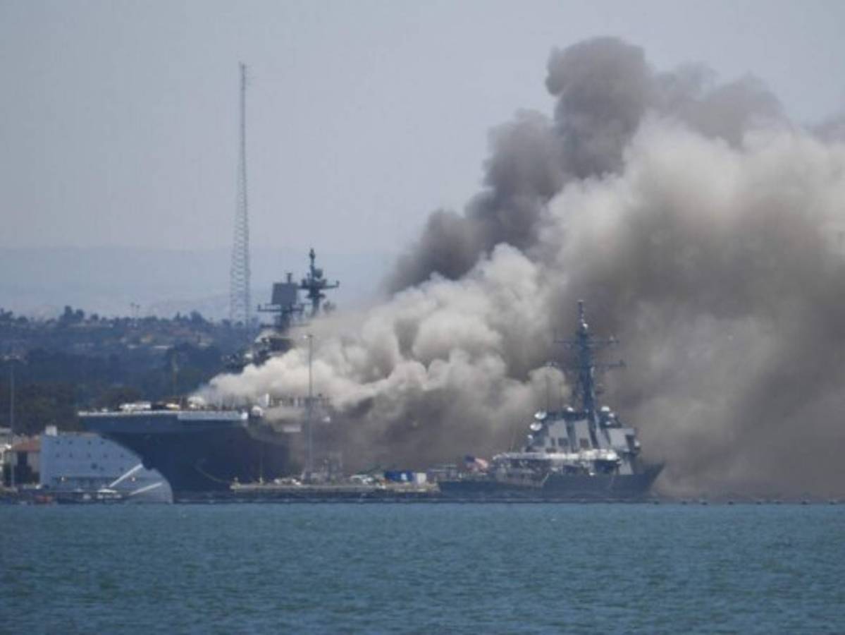 Smoke rises from the USS Bonhomme Richard at Naval Base San Diego Sunday, July 12, 2020, in San Diego after an explosion and fire Sunday on board the ship at Naval Base San Diego. (AP Photo/Denis Poroy)