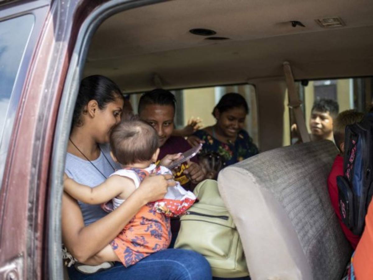 A group of migrants board a van to go get tested for Covid-19 at a migrant shelter on May 26, 2021 in Matamoros, Mexico. - Once, Abraham Barberi was known as the 'pastor of rappers,' host of Christian hip hop concerts targeting young drug dealers in Mexico in hopes of putting them on a different path. Now, he is making headlines by caring for a new flock: more than 200 people from Central and South America who dream of crossing the Rio Grande and migrating to the United States. (Photo by Sergio FLORES / AFP)