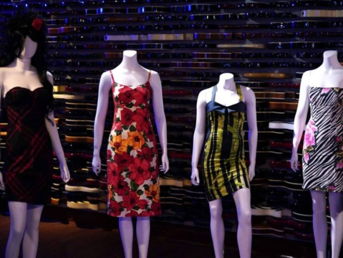 Dresses are displayed during the New York press and public exhibition of the 'Property From The Life And Career Of Amy Winehouse' by Julien's Auctions in New York, October 11, 2021. - Dozens of dresses, including the famous one Amy Winehouse wore during her dramatic last concert in 2011, books, records, bags and objects that belonged to the British soul diva who died ten years ago will be auctioned in California in November. The US exhibition Tour will be at Hard Rock Cafe New York October 11-17, before the two-day auction event taking place live November 6 and 7. (Photo by TIMOTHY A. CLARY / AFP)