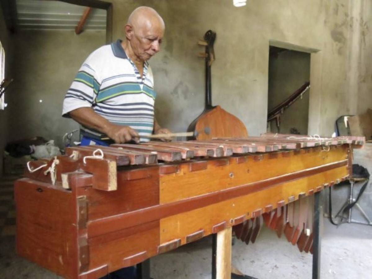 Un tallador de notas musicales en trozos de hormigón y cedro