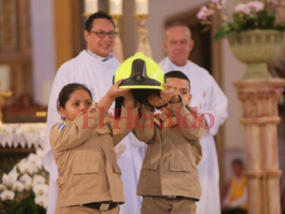 Estos dos bomberos infantiles en la presentación del casco protector.